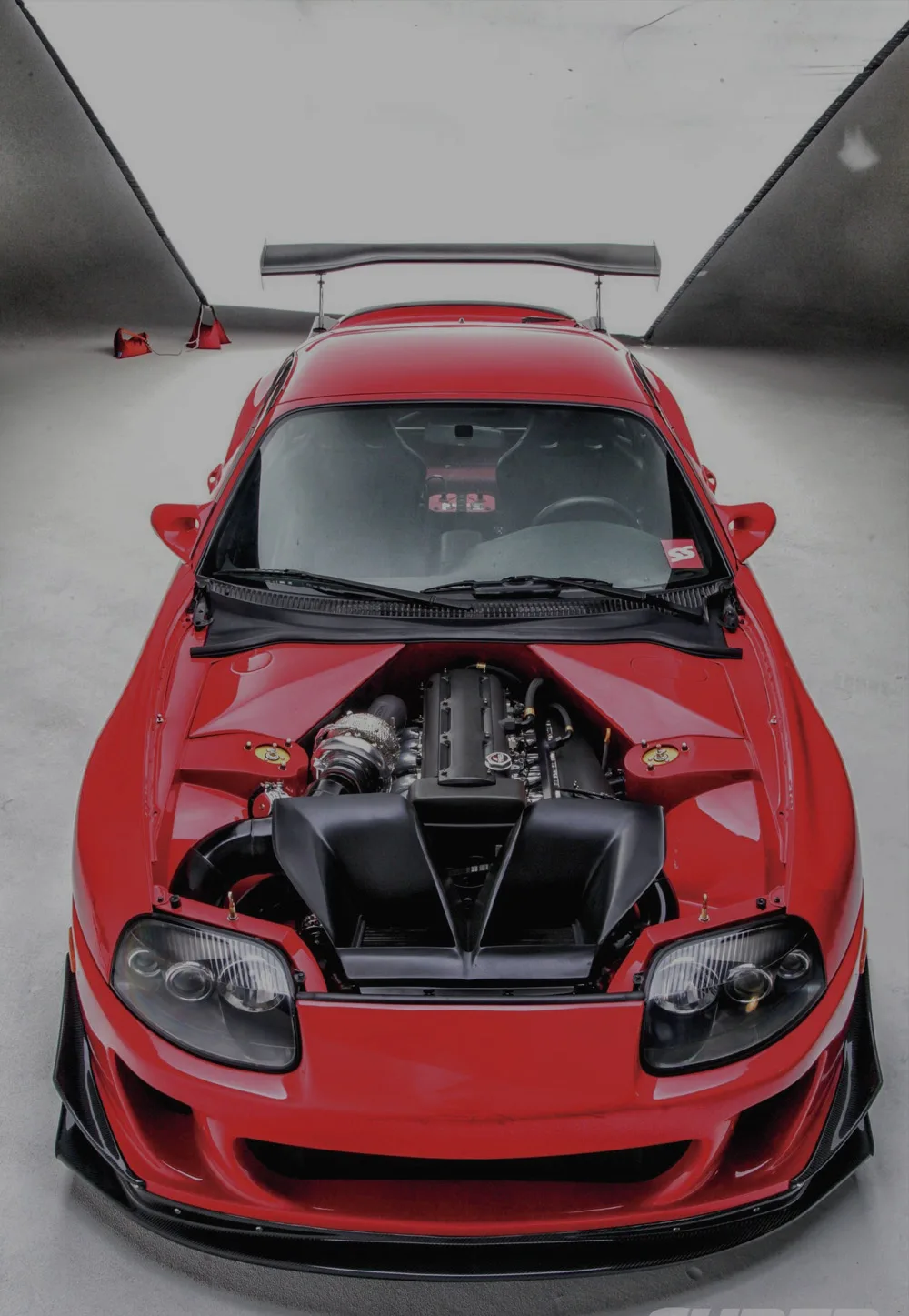 Red performance car featured on Enrique’s current public site