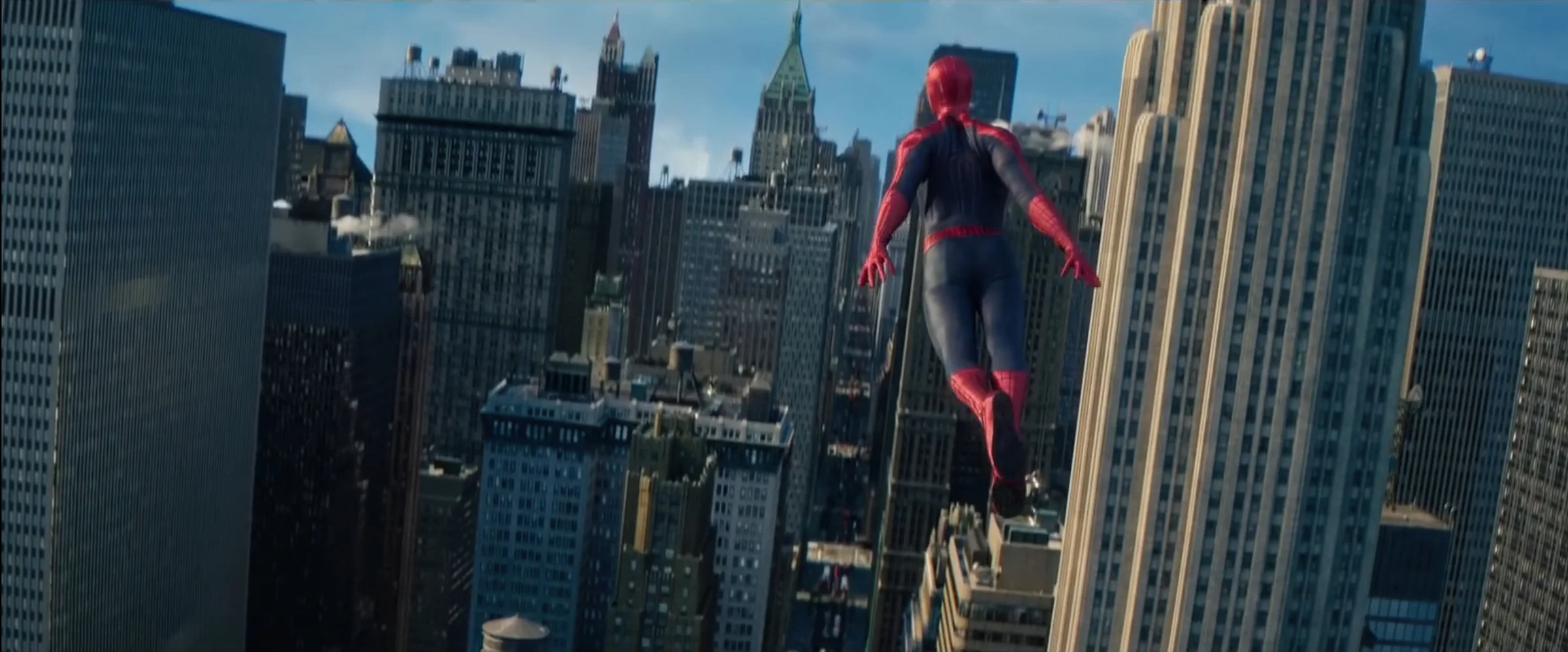 Spider-Man swinging between buildings in The Amazing Spider-Man 2